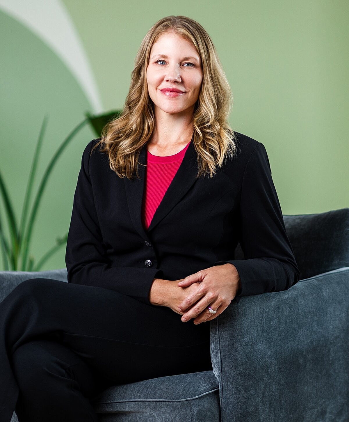 Man in suit smiling in modern office setting
