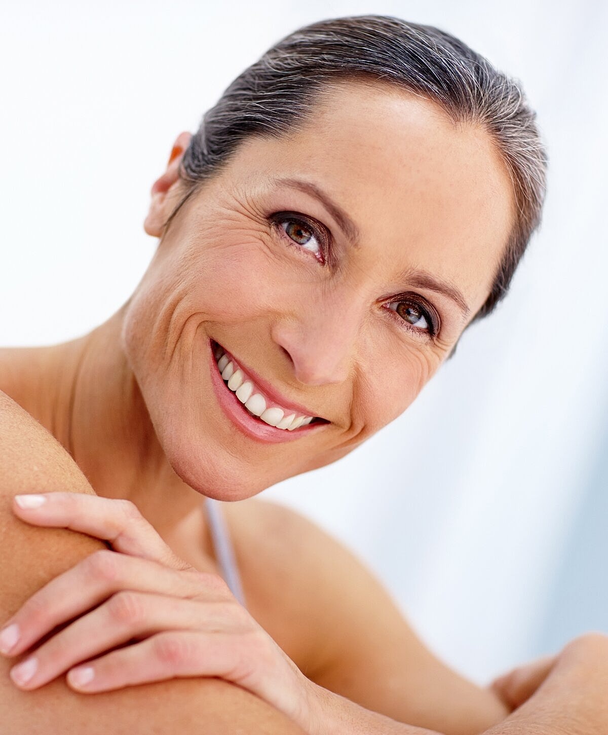Smiling woman with healthy skin and radiant expression.