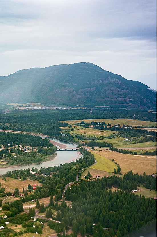 Scenic landscape with mountain, river, and trees.