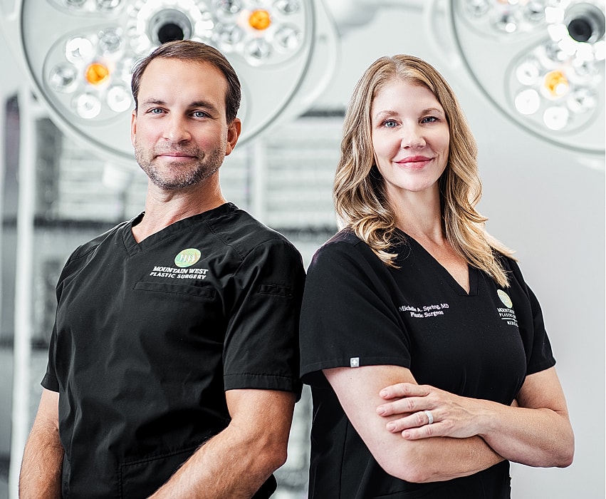 Doctor consulting with patient in plastic surgery office.