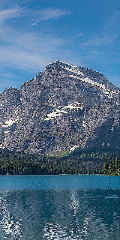 Majestic mountain reflected in serene lake.