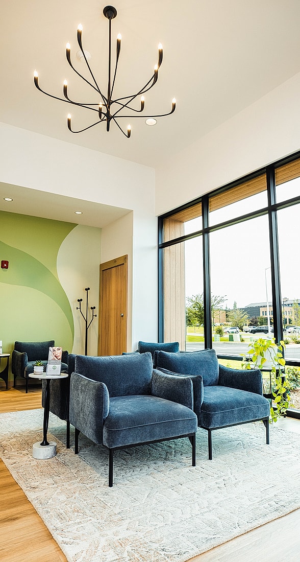 Modern living room with stylish blue chairs.