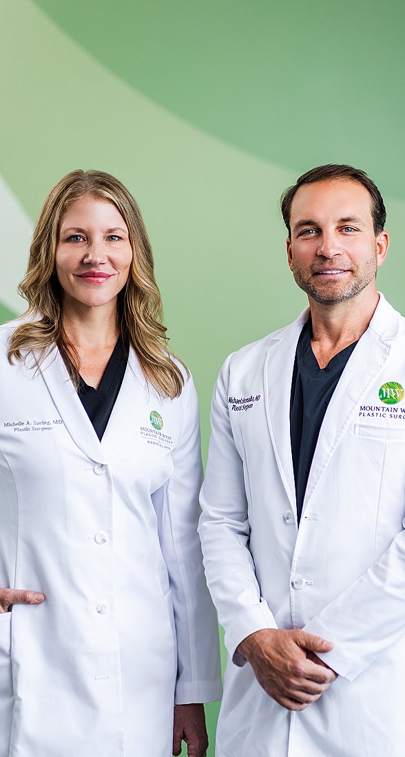 Two plastic surgeons in white lab coats.