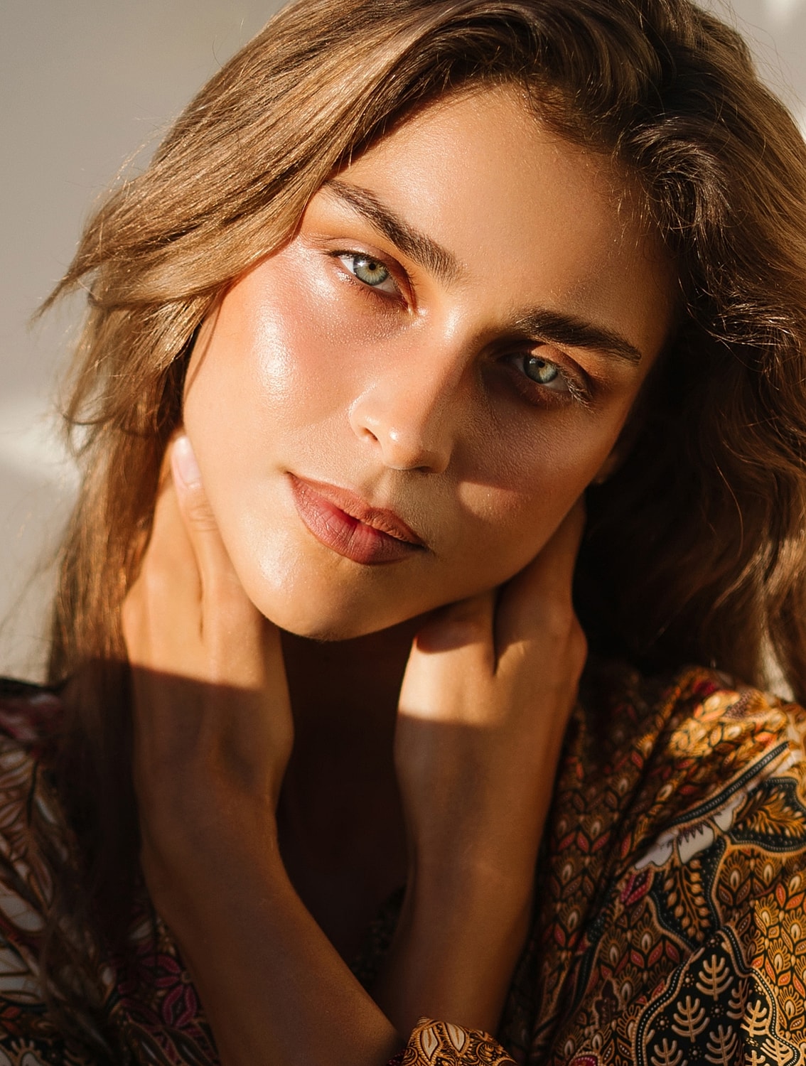 Woman with glowing skin and expressive gaze.