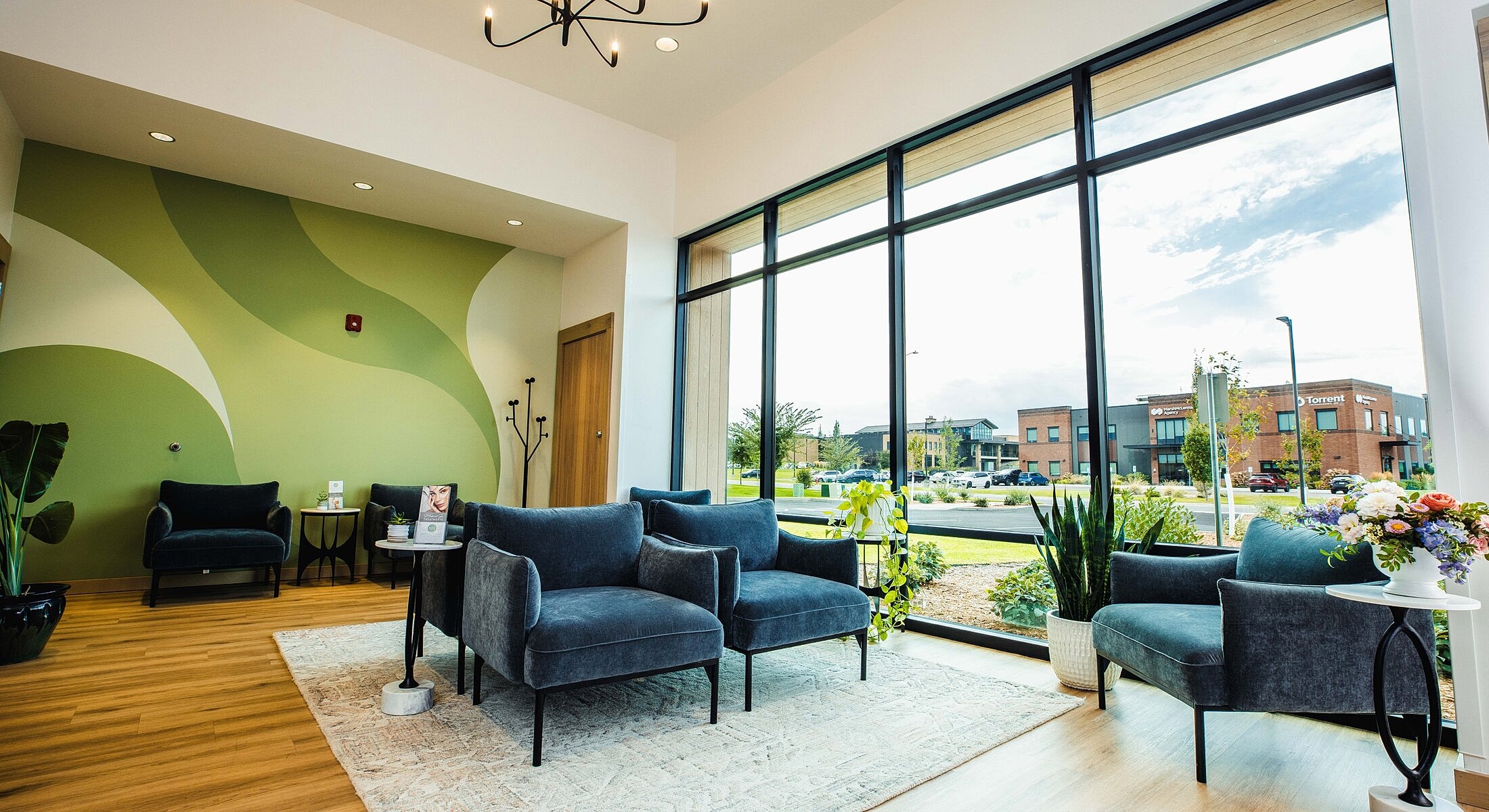 Modern waiting area with large windows and plants.